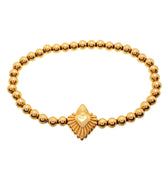 Gold bracelet made of small gold balls with a heart-shaped charm in the center, secured with a spring ring clasp